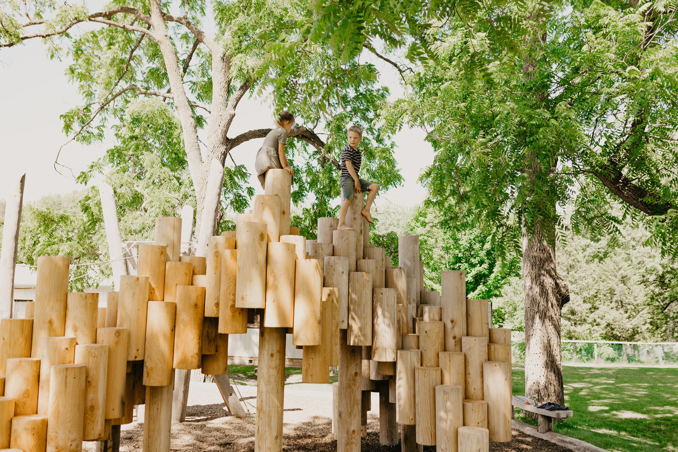 A playground sculpture made of logs
