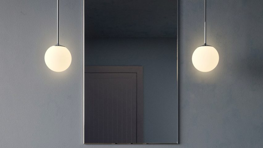 Lamps hanging either side of mirror in bathroom