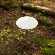 A small circular stool sitting in a forest