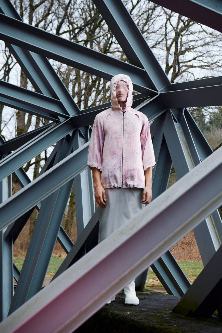 Fashion campaign photo for the Normal Phenomena of Life brand featuring a veiled figure standing on a bridge