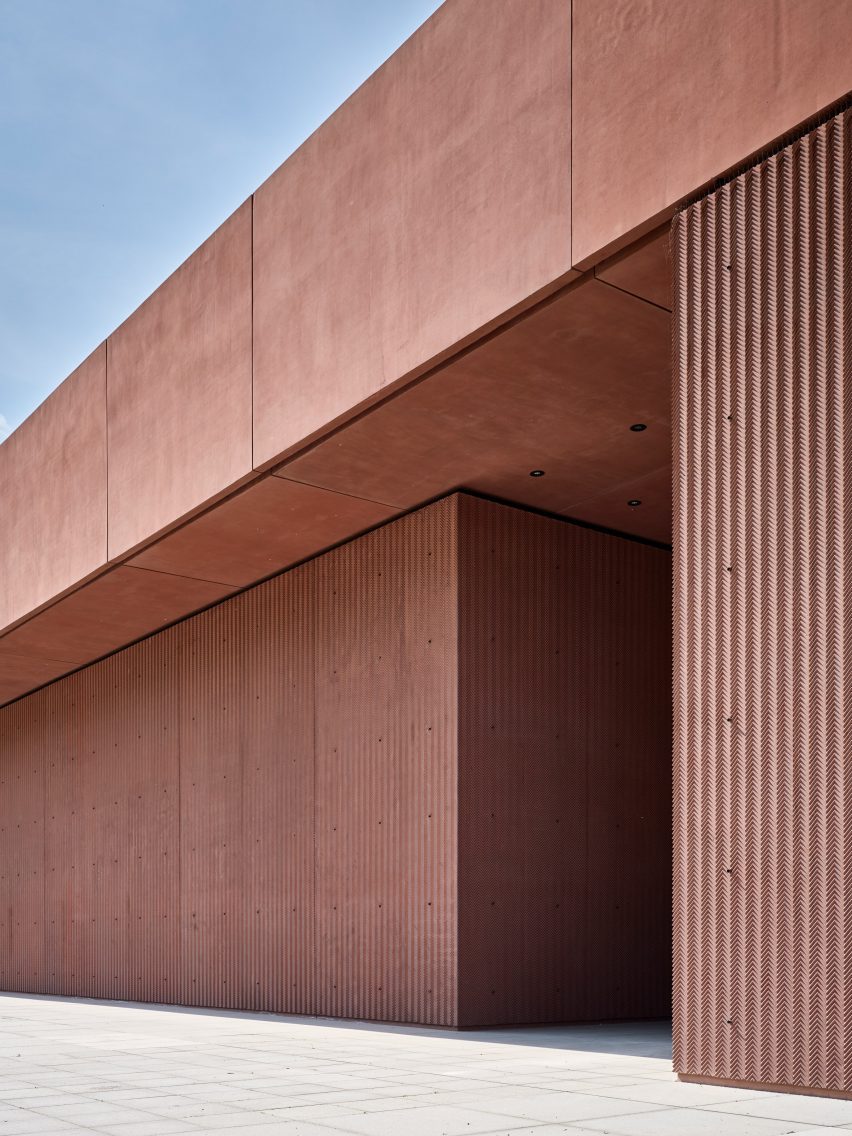 Pink-concrete facade imprinted with chevrons