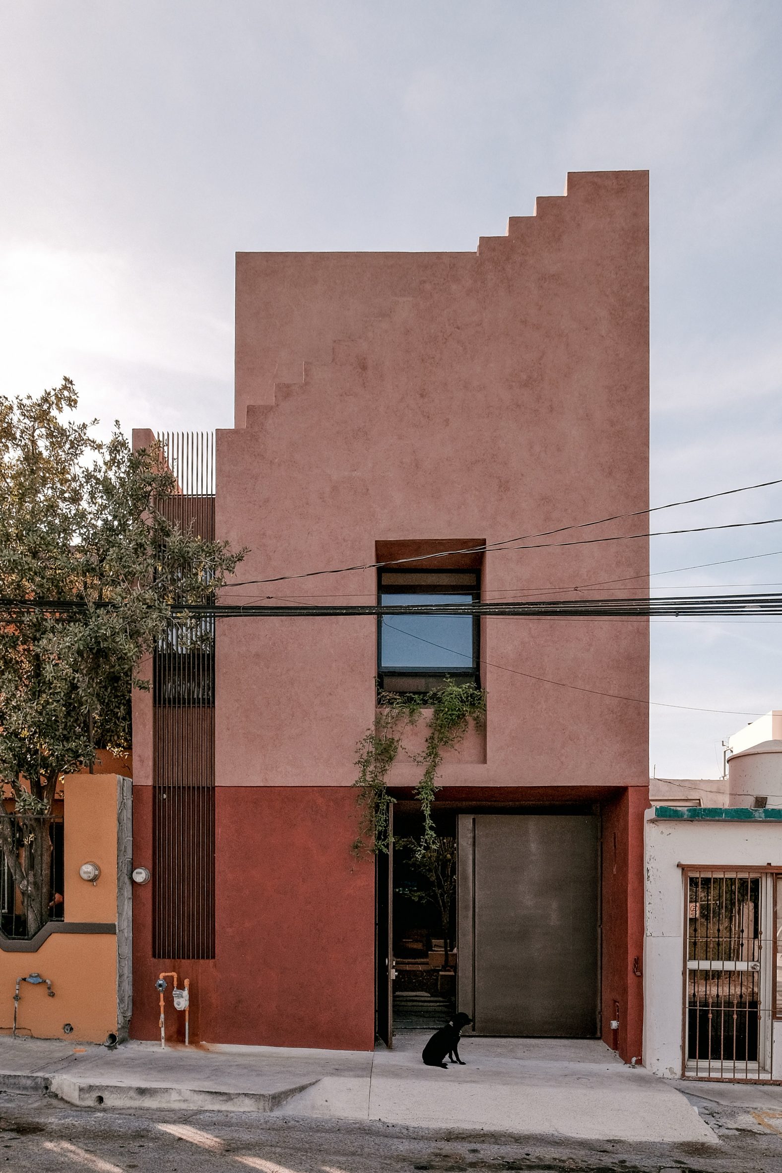 Red concrete house by Práctica Arquitectura