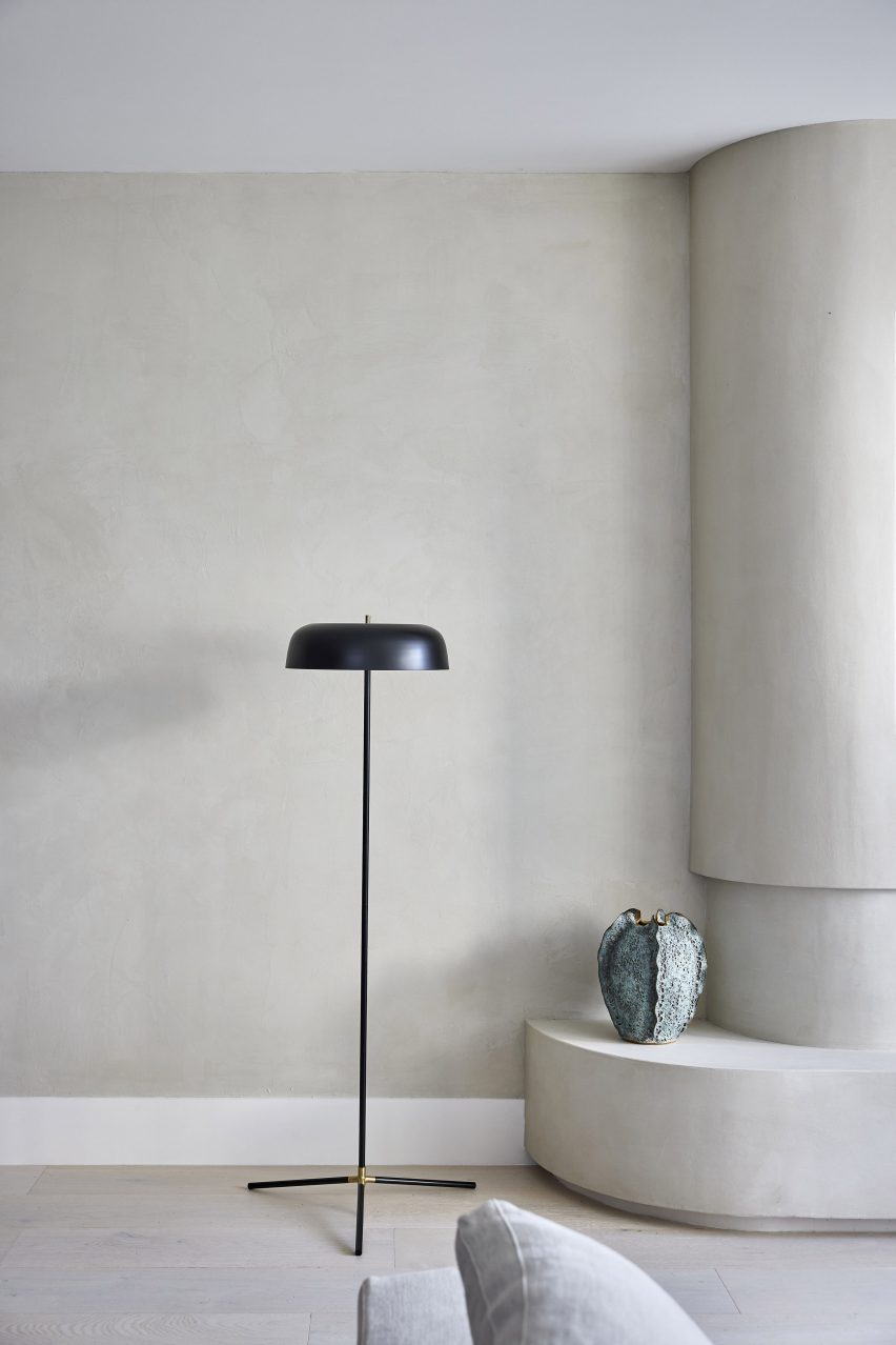 A single black lamp in a beige room