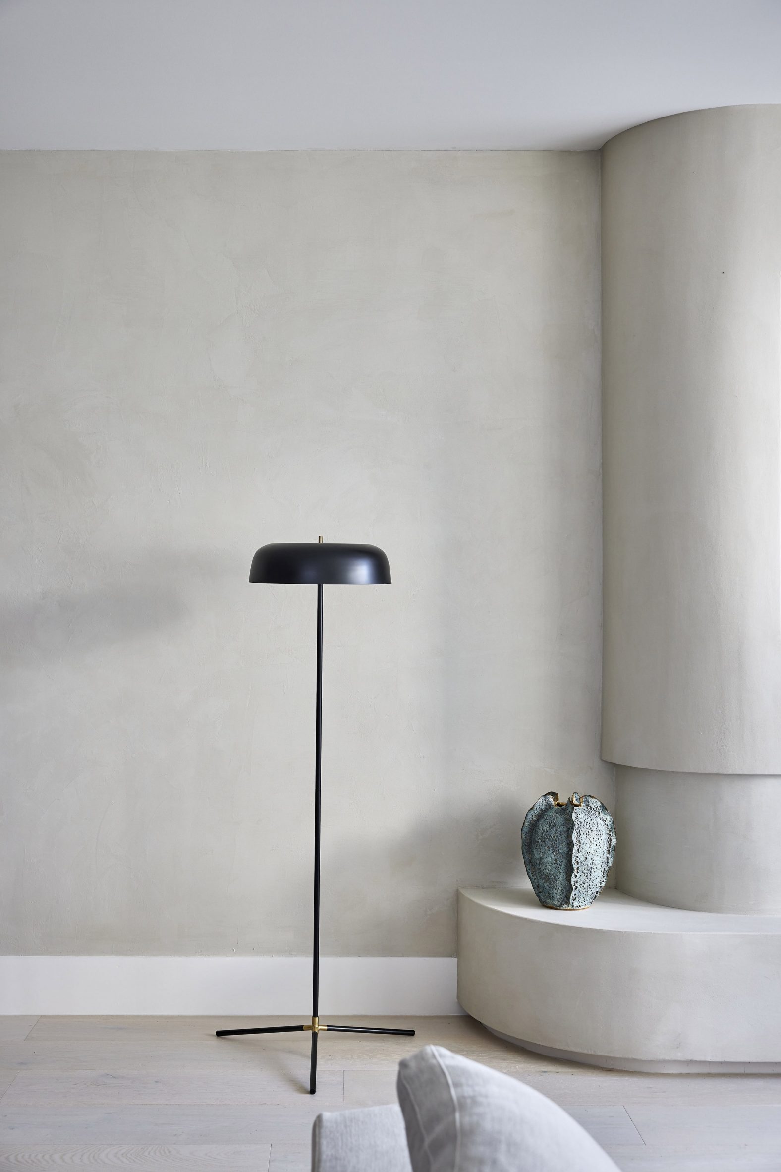 A single black lamp in a beige room