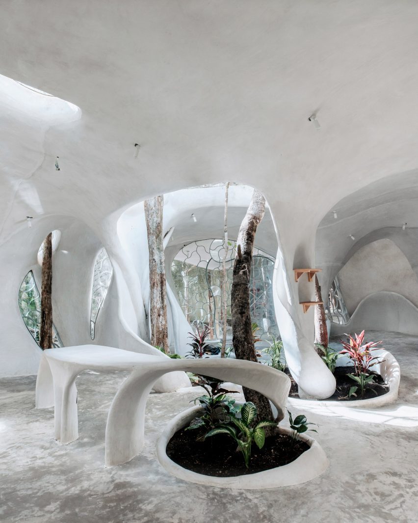 An ،ic, white interior with planting beds
