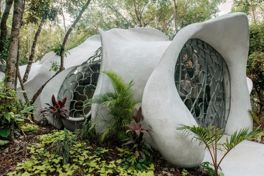 A bulbous concrete form installed in the jungle