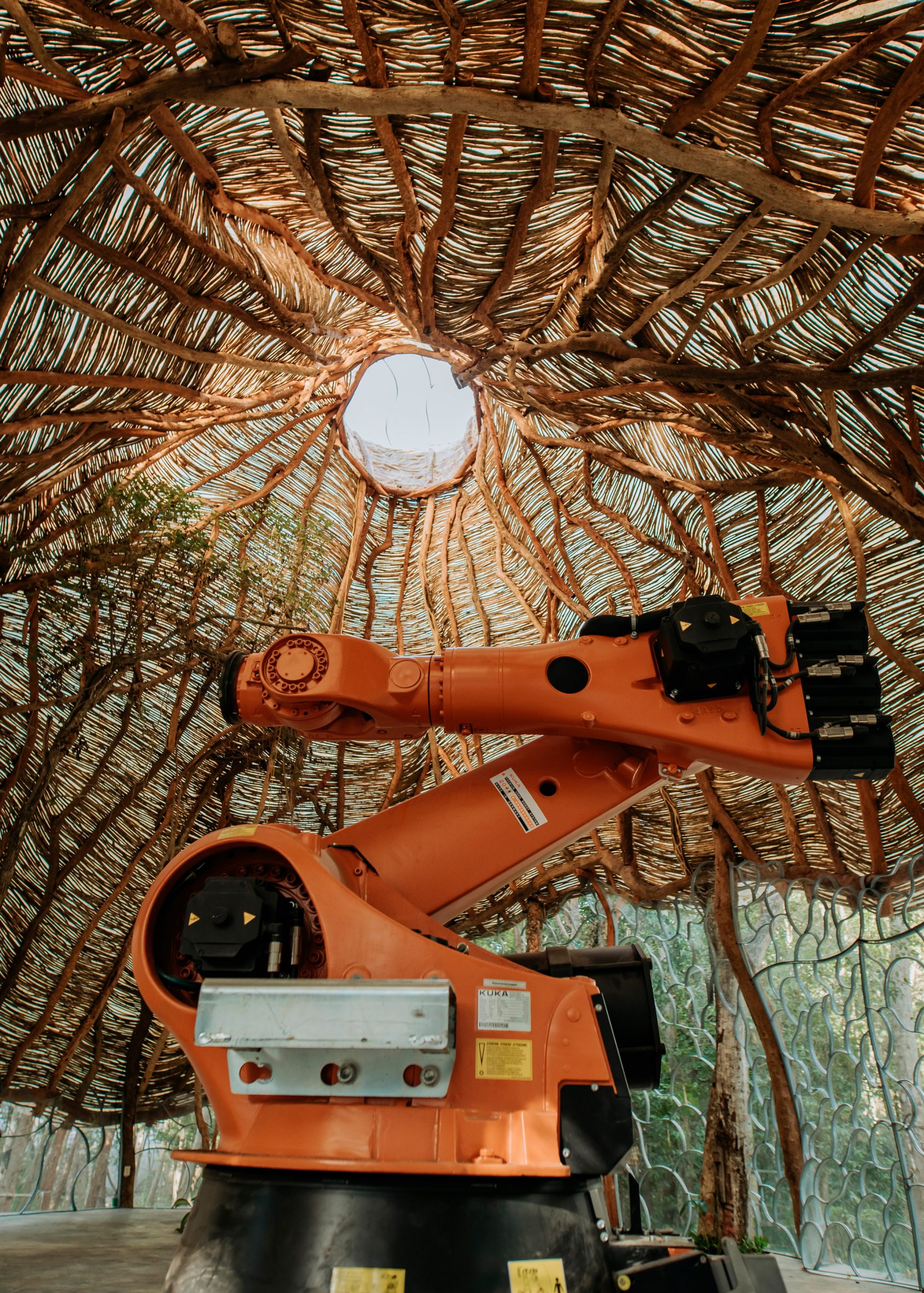 A robot underneath a dome made of sticks