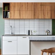 Kitchen with wood top units, white bottom units and white tiled backsplash