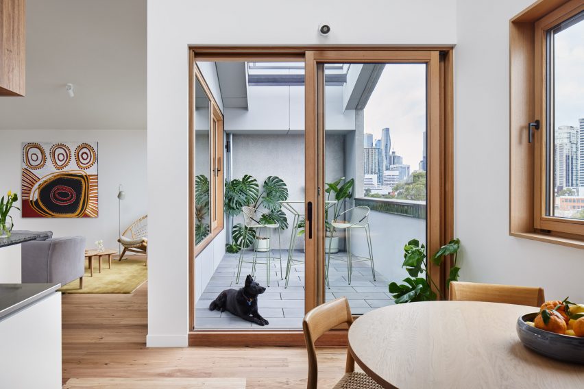 Interior space with wooden floors and glass doors leading to the balcony