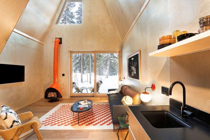 Orange custom Malm fireplace in paneled cabin interior