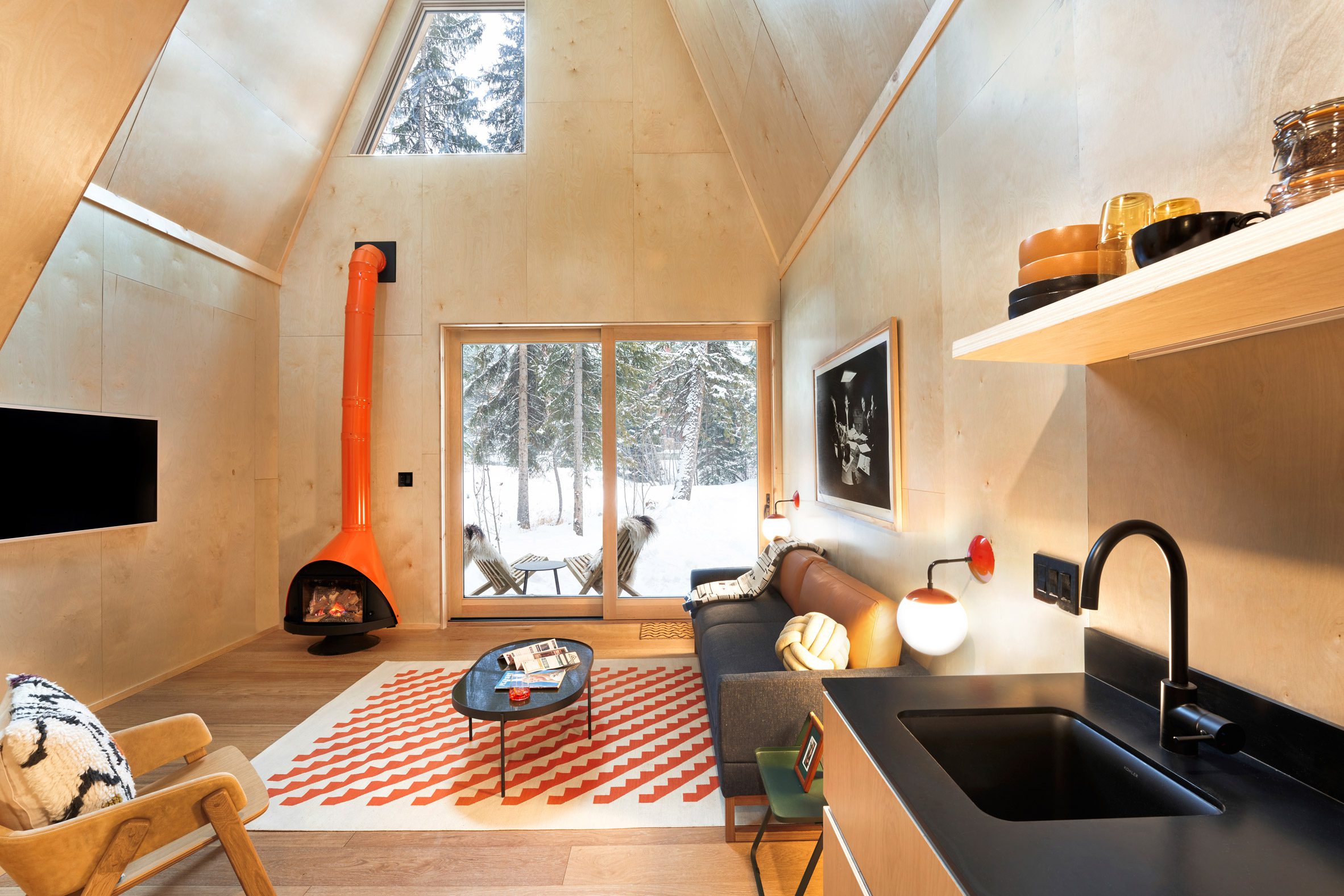 Orange custom Malm fireplace in paneled cabin interior