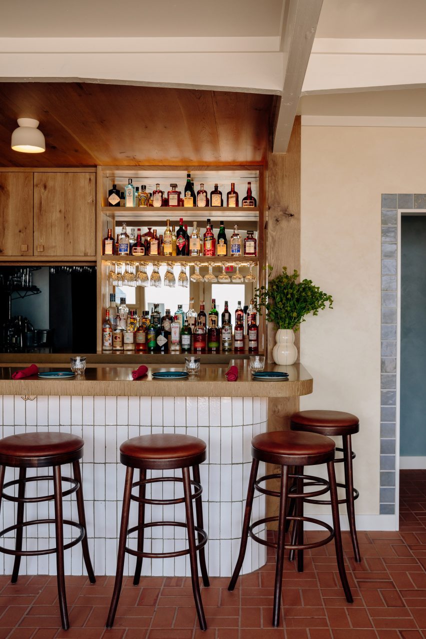 Reclaimed wood back bar and white-tiled counter front