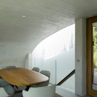 Concrete dining room with curving walls and ceiling
