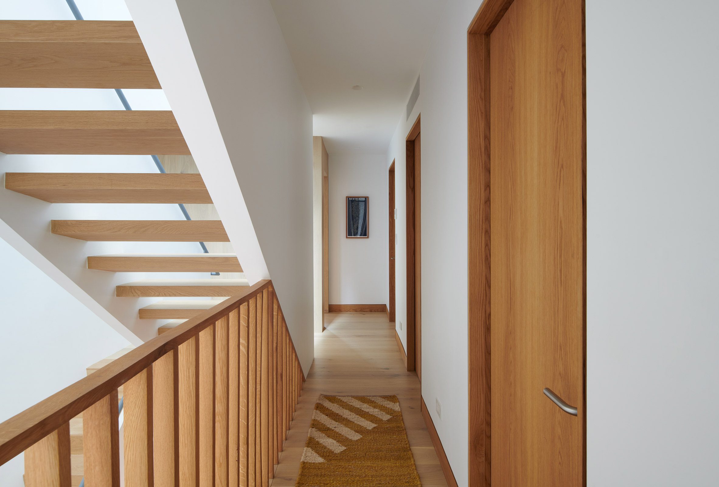 Switchback staircase beside a corridor with wooden doors