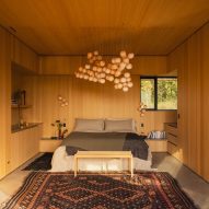 A bedroom with wooden walls