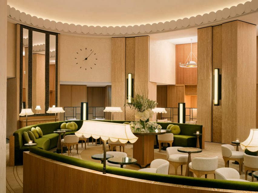 Hotel interior featuring green furnishings and white lamps