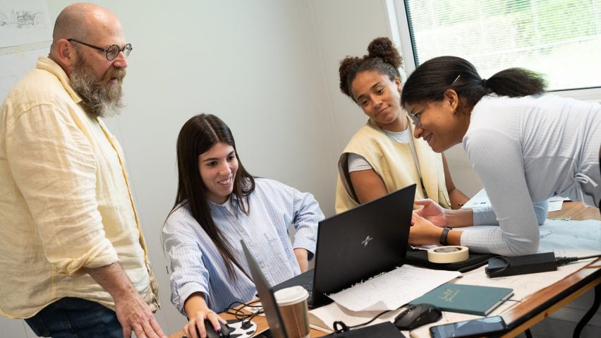 Photo of people looking at a laptop