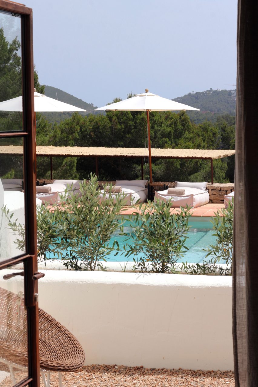 View through open doors of a swimming pool in Aguamadera hotel in Ibiza