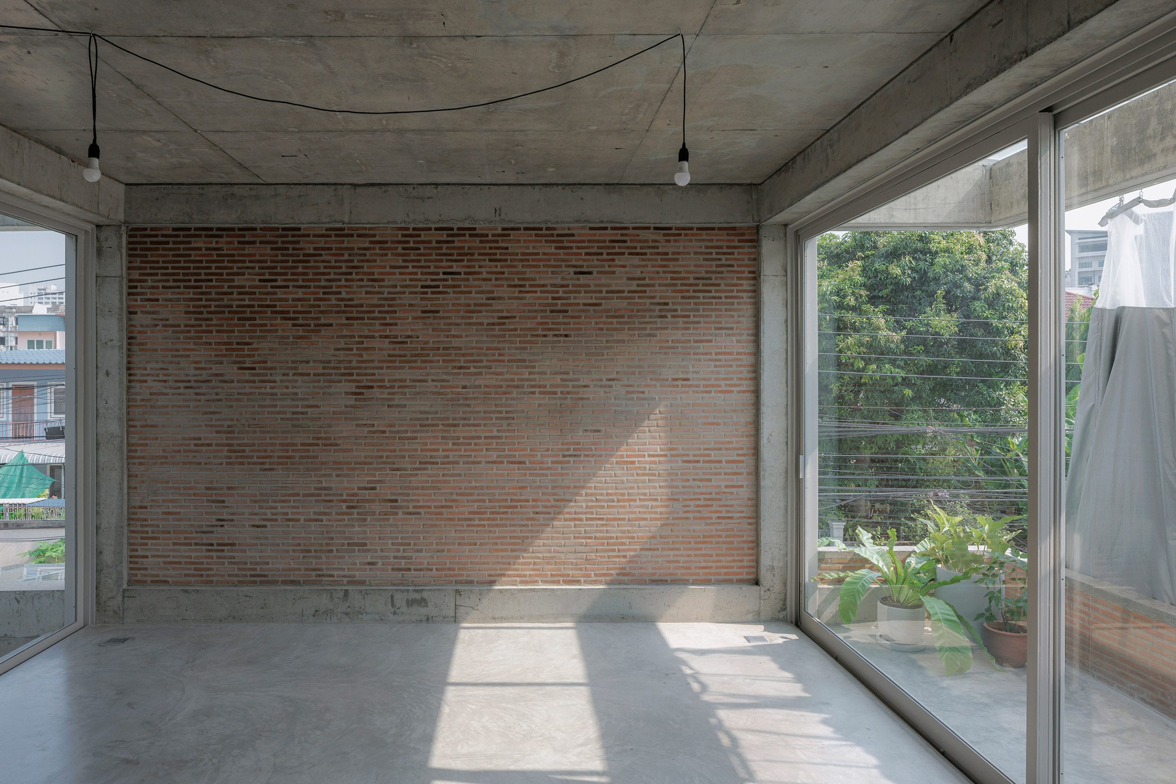 Exposed brick and concrete in House K by Bangkok Tokyo Architecture