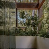 An open air bathroom with jungle plants
