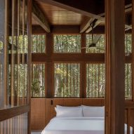 A crisp white bed in a treehouse hotel