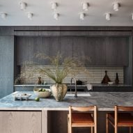 A kitchen with gray cabinetry and large kitchen island