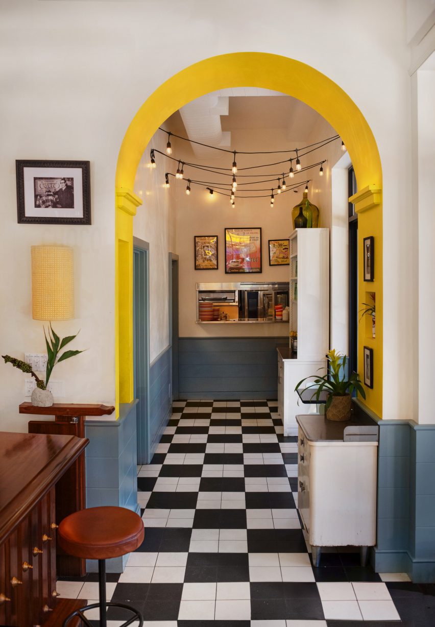 Yellow-lined arched opening with chequerboard floors running through