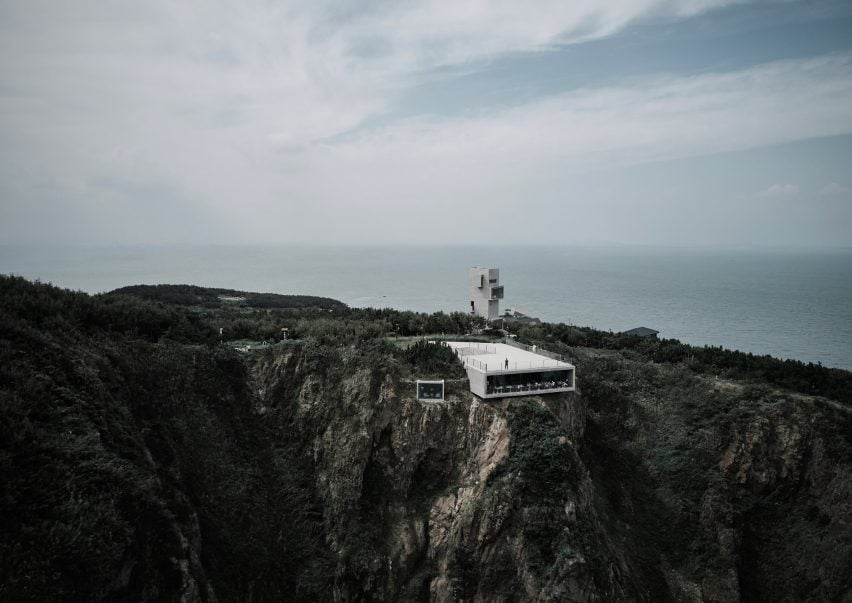 Aerial view of concrete building embedded into cliff edge in China
