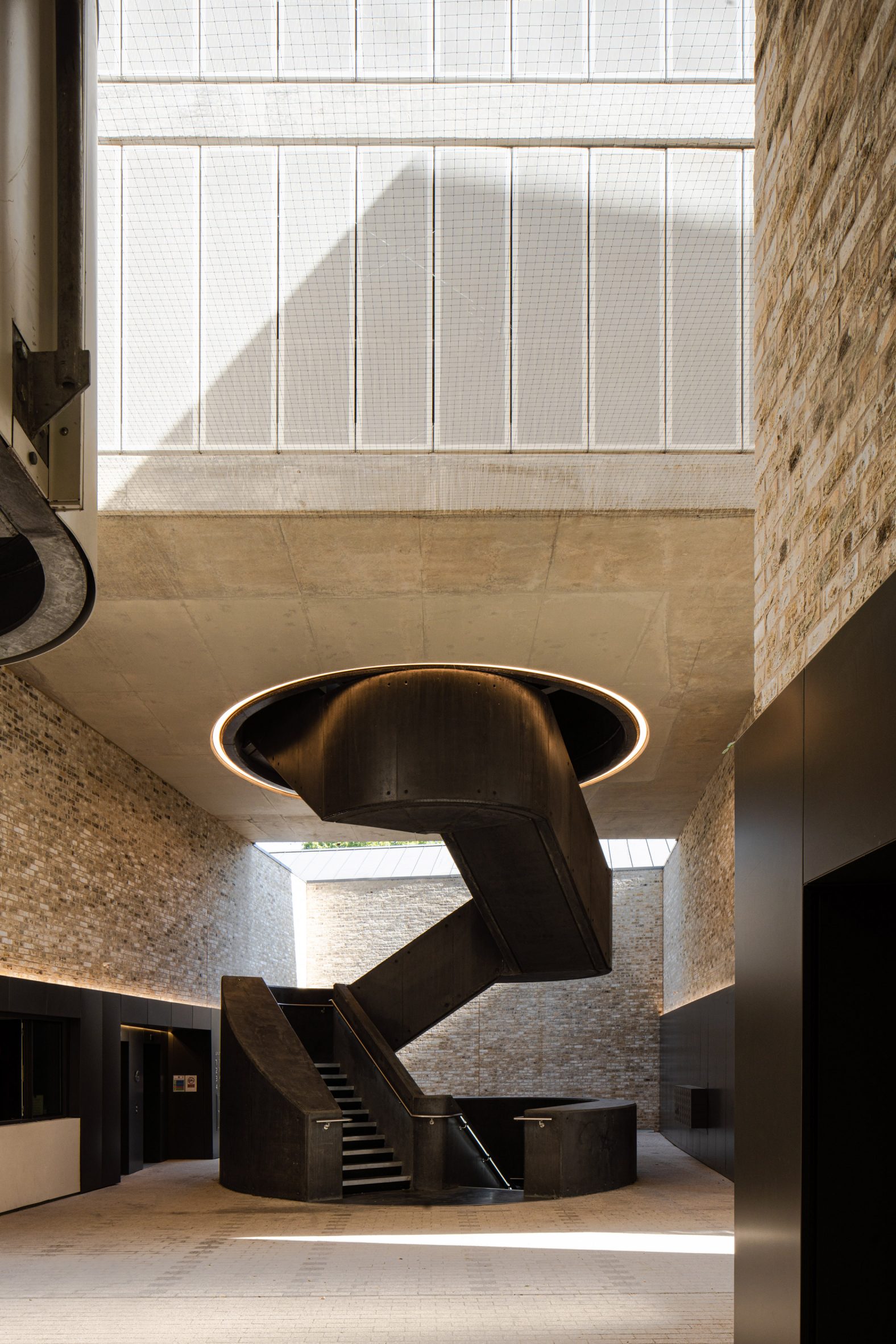 Black spiral staircase at The Tannery by Coffey Architects