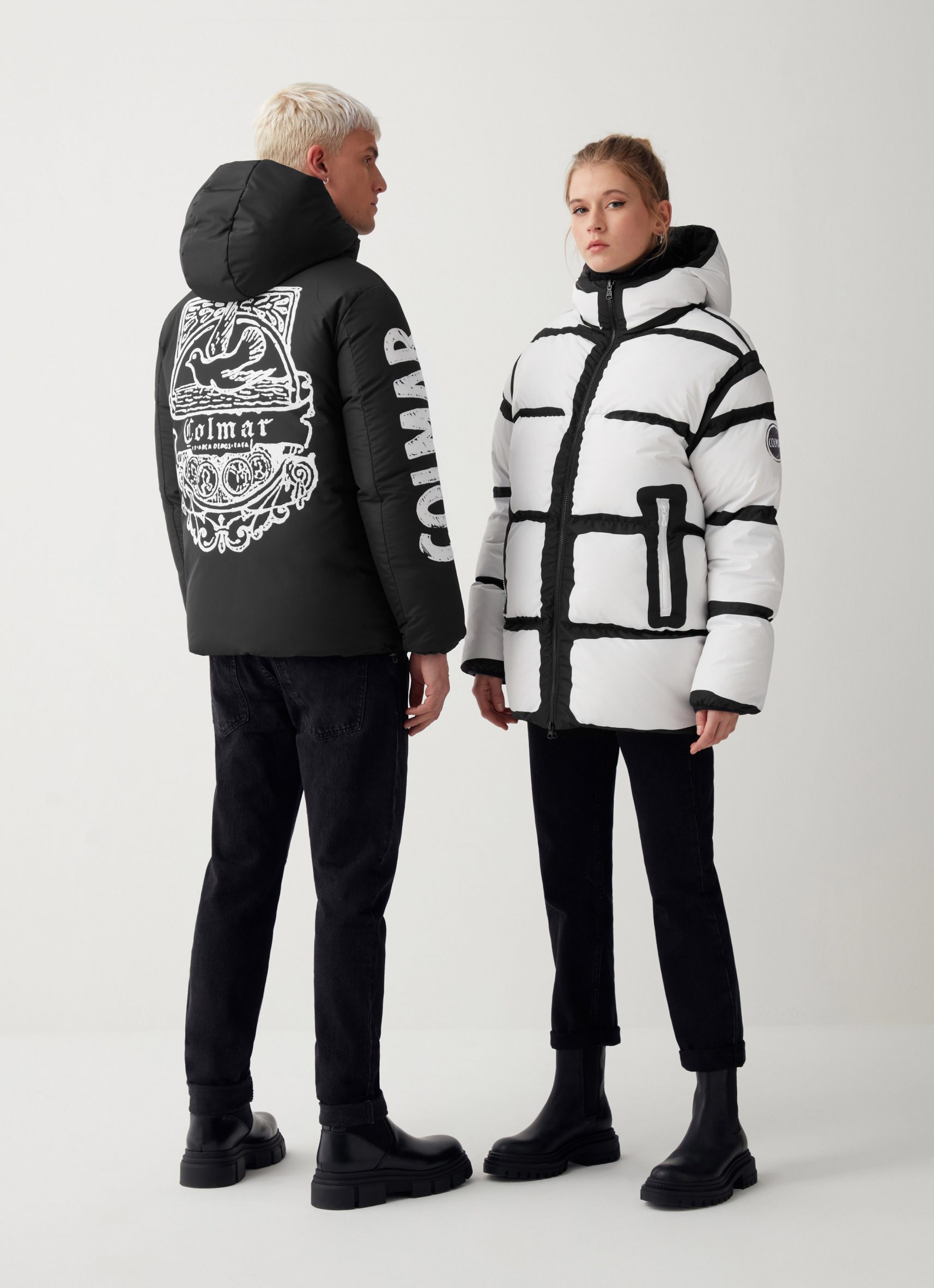 Two models wearing black and white ski jackets