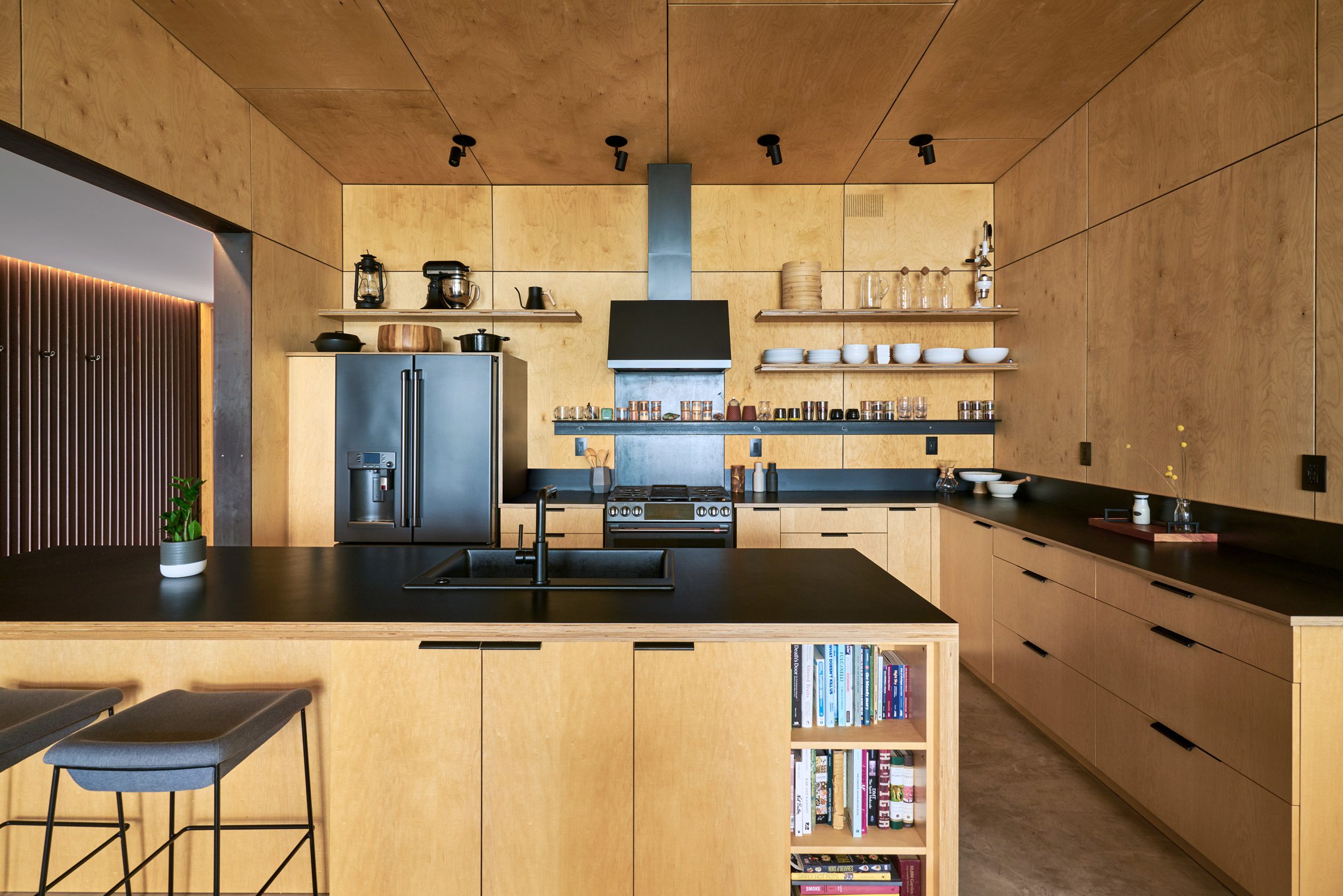 A kitchen made of light wood panelings