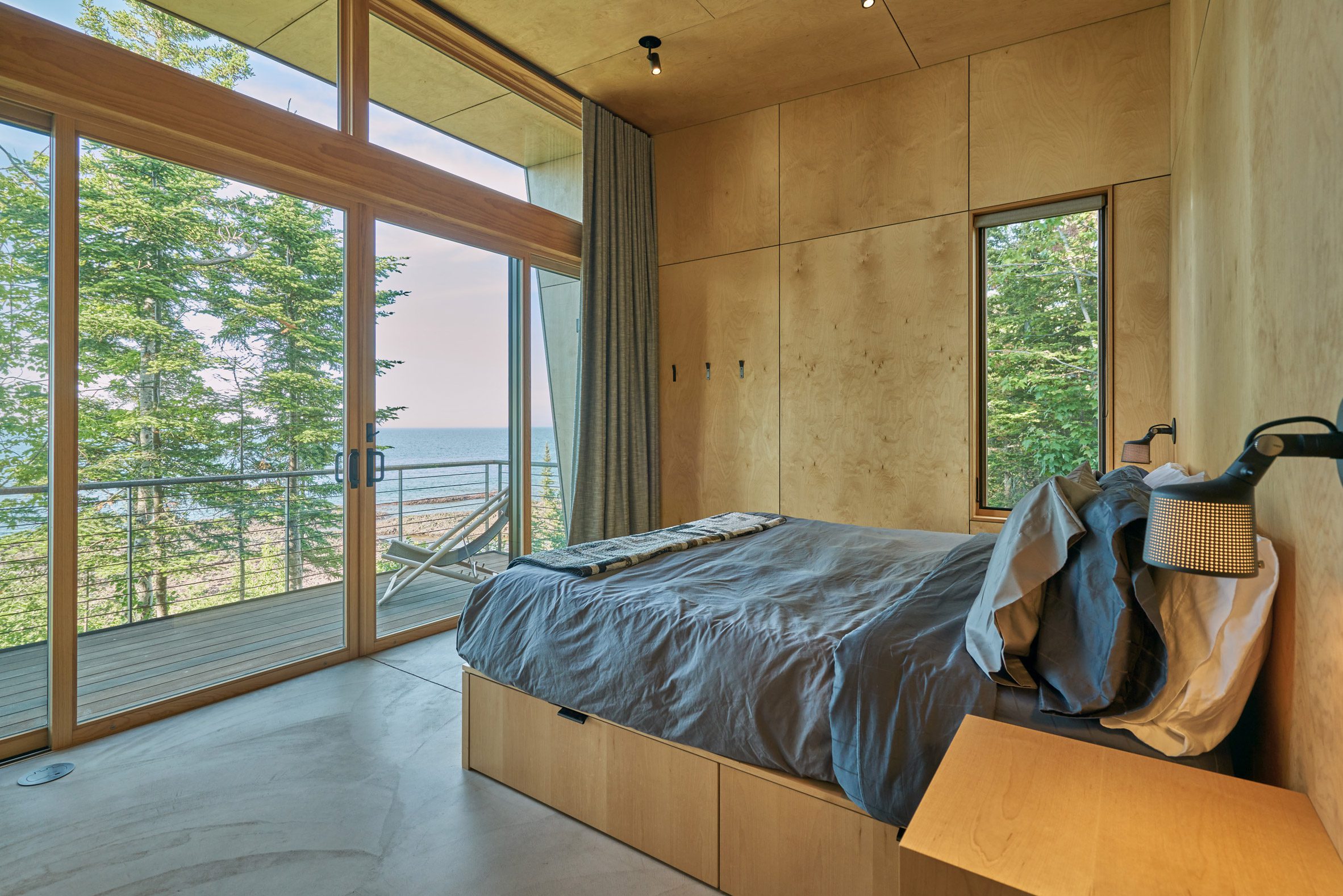 A bedroom with wood paneled walls