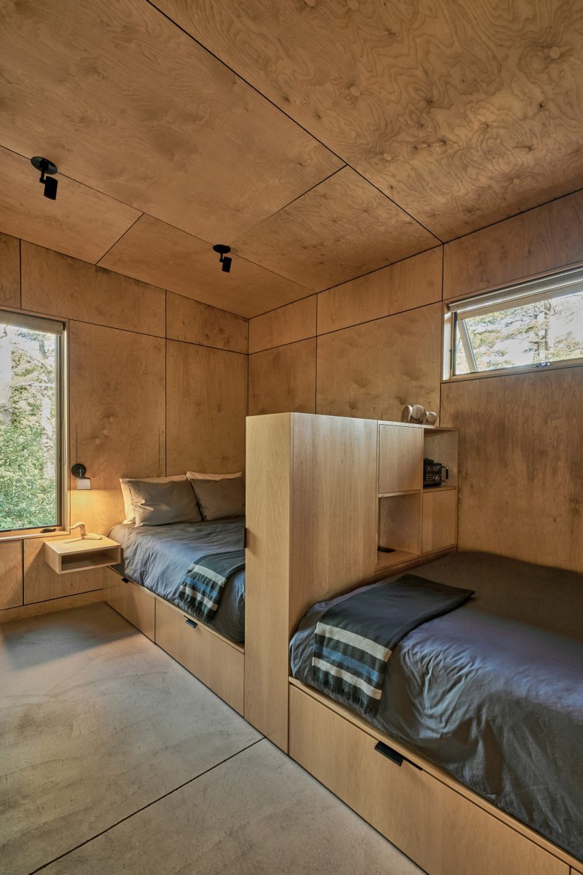 Two twin beds in a wooden room