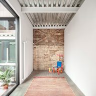 Remodelled Barcelona apartment with a metal ceiling and brick accent wall