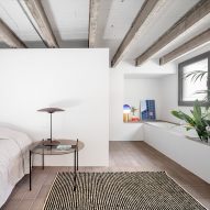 Bedroom with white walls and exposed ceiling beams