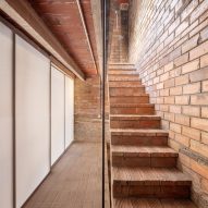 Brick staircase in a remodelled Barcelona apartment by CRÜ