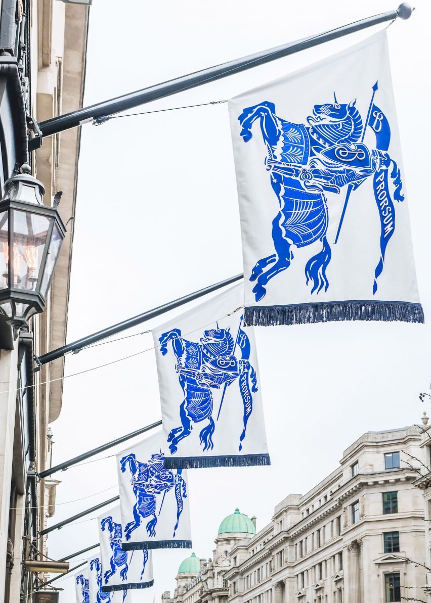 Flags on shop front showing blue knight riding horse