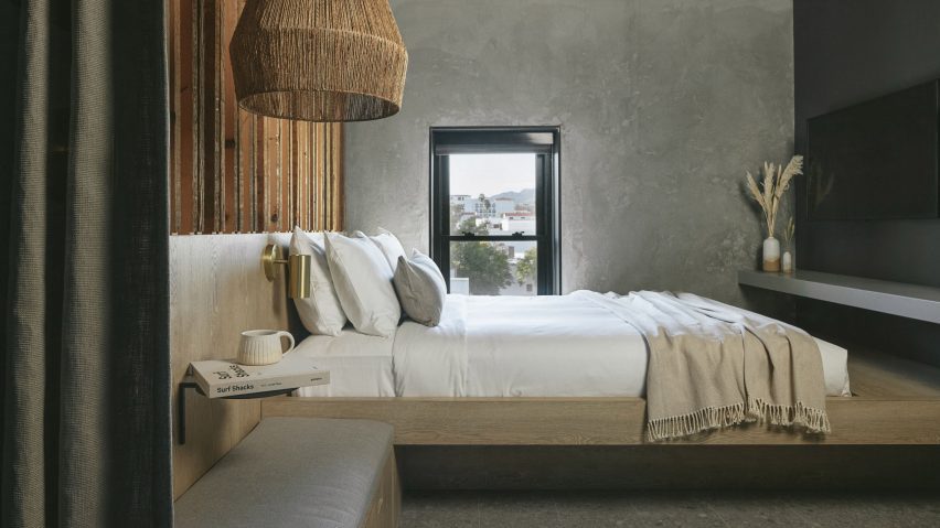 A bedroom with gray walls and rattan lamp