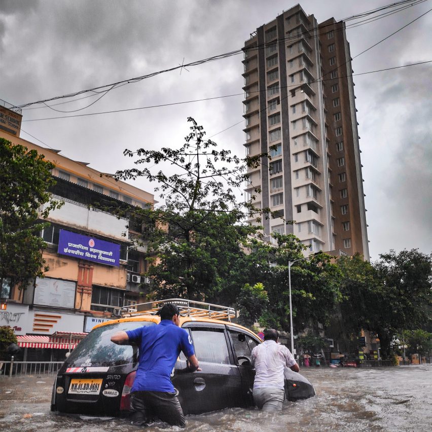 Men pushing car in a flood