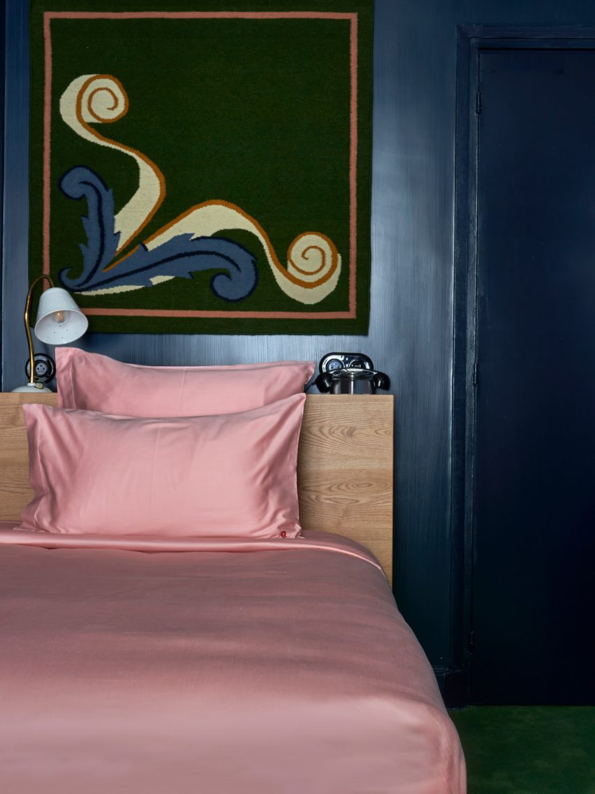 Pink satin sheets on bed in Paris hotel