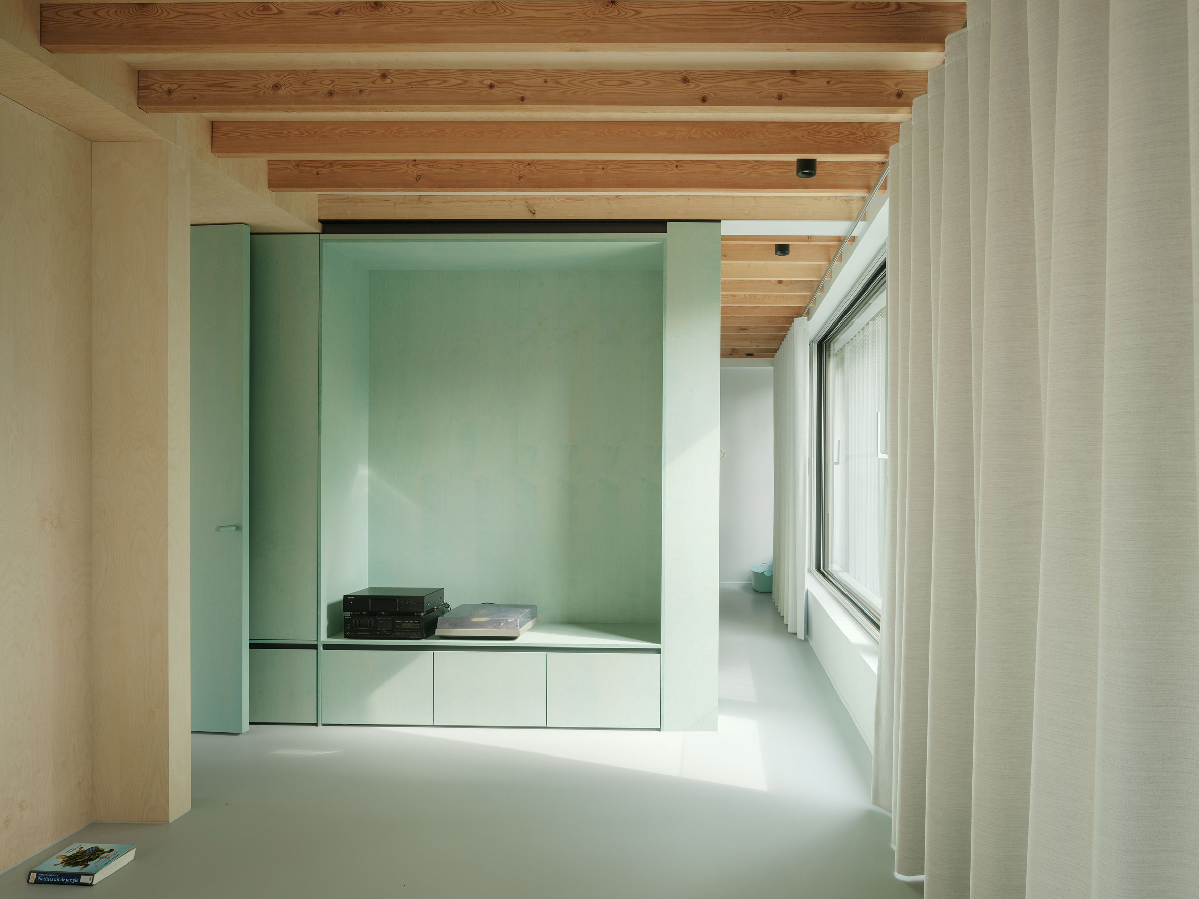 Mint green built-in storage in a home by ISM Architecten