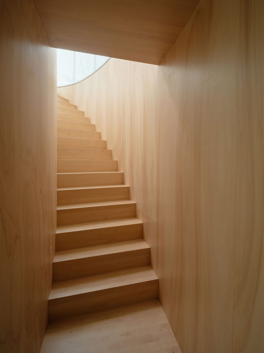 Wood-lined staircase at the BEEV home by ISM Architecten