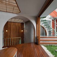 Corridor with wood flooring, archways and a grassy outdoor terrace