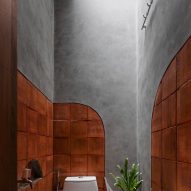 Concrete and wood bathroom with a skylight
