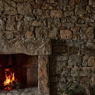 Stone wall surrounding a fireplace