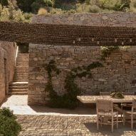 Outdoor dining table and chairs on a stone terrace