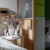 Coloured walls in the bathroom contrast the raw concrete of the main space