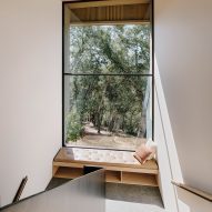 A window seat in front of a large window