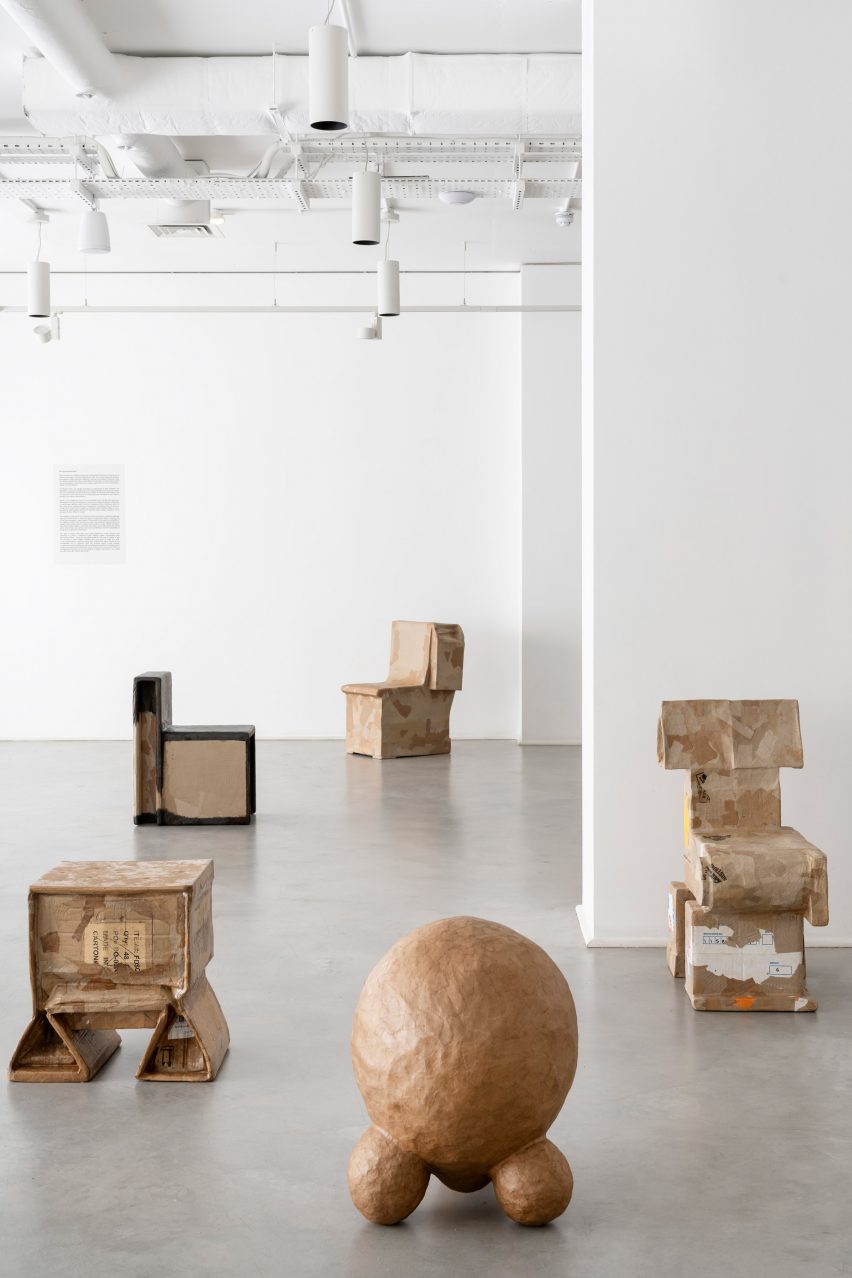 Chairs and stools made from cardboard in a gallery