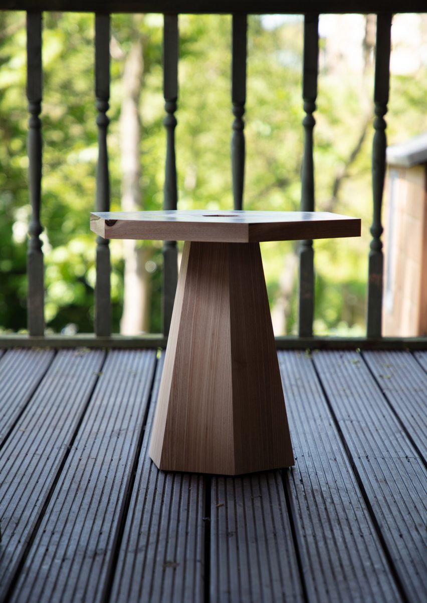 Hexagonal side table on decked outside area